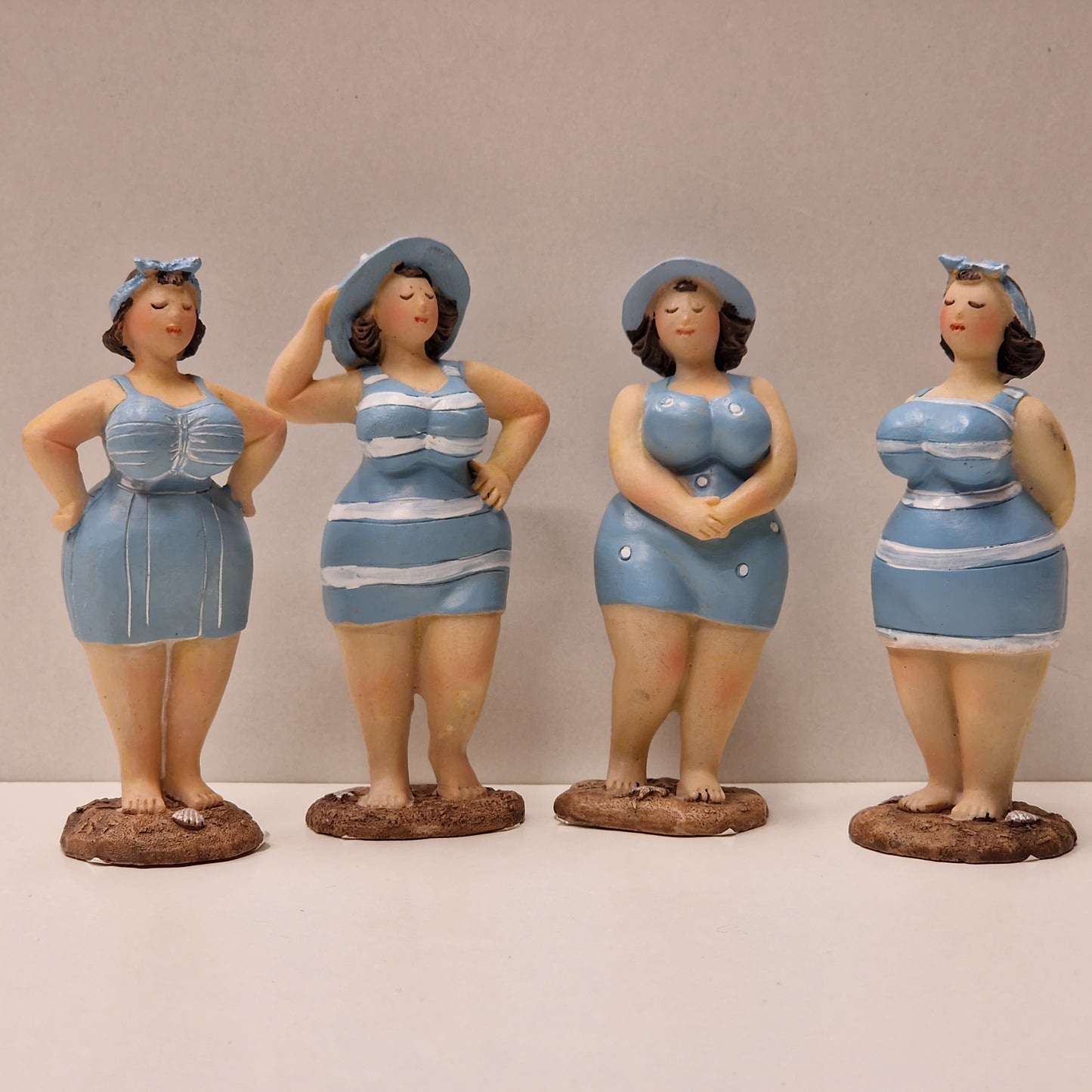 Lubben dame i stripete badedrakt og hårbånd, lys blå